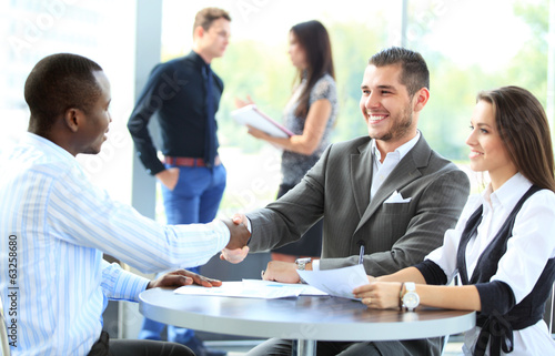 Photo: Business people shaking hands, finishing up a meeting Business people shaking hands, finishing up a meeting