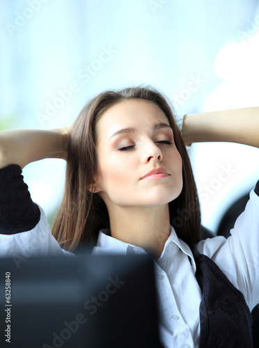 Photo: Portrait of an elegant cheerful woman relaxing in office Portrait of an elegant cheerful woman relaxing in office