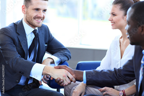 Photo: Business people shaking hands, finishing up a meeting Business people shaking hands, finishing up a meeting