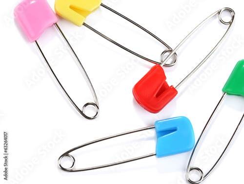 Photo: Multicolor safety pins isolated on white Multicolor safety pins isolated on white