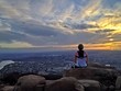 Female hiker watching the sunset over the city of San Diego Female hiker watching the sunset over the city of San Diego