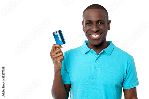 Photo: Smiling guy holding credit card Smiling guy holding credit card