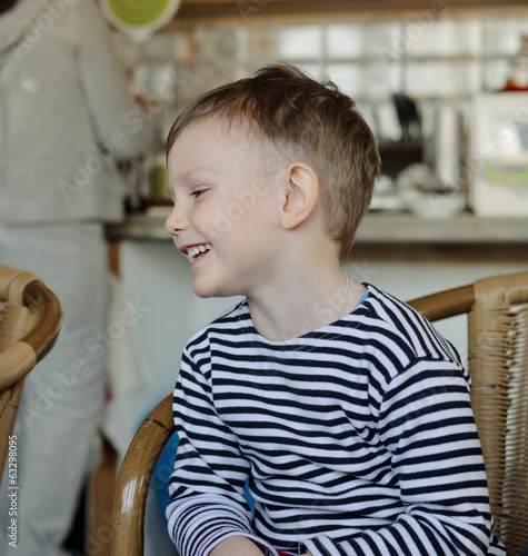 Photo: Little boy sitting laughing Little boy sitting laughing
