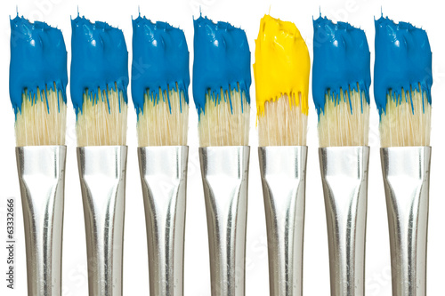 Photo: Paint brushes with blue and yellow paints Paint brushes with blue and yellow paints