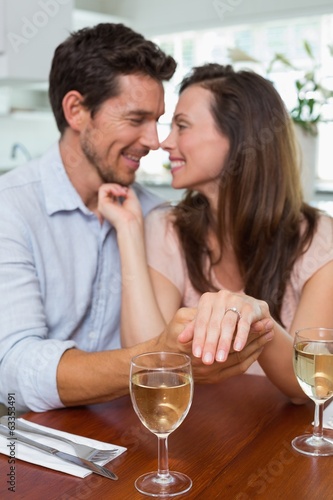 Photo: Woman showing engagement ring besides man Woman showing engagement ring besides man