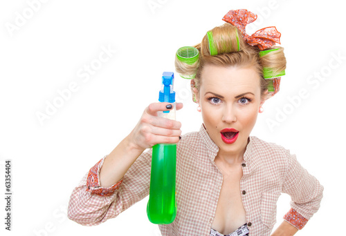 Photo: Funny housewife / woman spraying the cleaner Funny housewife / woman spraying the cleaner