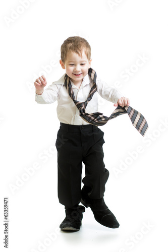 Photo: kid boy trying to go on father shoes kid boy trying to go on father shoes