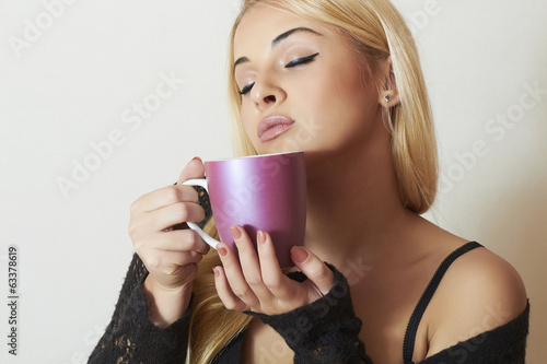 Photo: Beautiful blond woman drinking Coffee. Cup of tea.Delicious Beautiful blond woman drinking Coffee. Cup of tea.Delicious