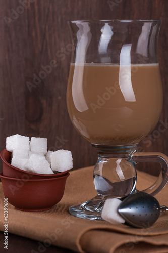 Photo: White sugar with a glass of coffee with milk White sugar with a glass of coffee with milk