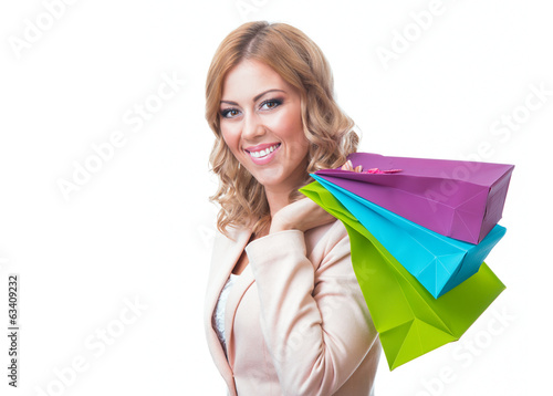 Photo: Cheerful young girl holding shopping bags Cheerful young girl holding shopping bags