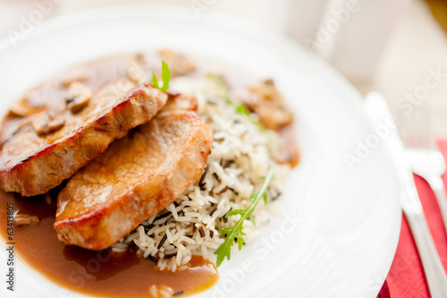 Photo: grilled succulent pork chop and rice as main course grilled succulent pork chop and rice as main course