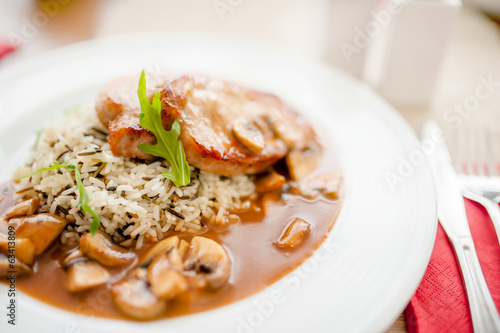 Photo: Juicy, succulent grilled pork chops with mushrooms and rice Juicy, succulent grilled pork chops with mushrooms and rice