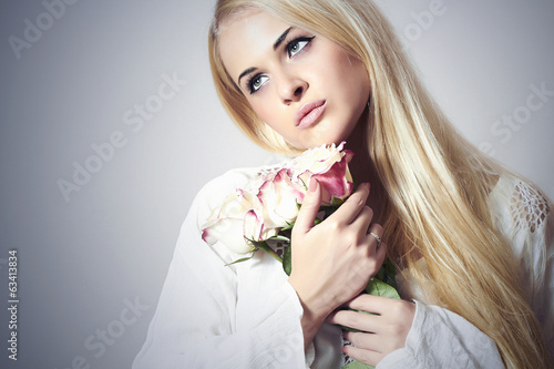 Photo: Beautiful Blond Woman with Bouquet of Flowers.girl and roses Beautiful Blond Woman with Bouquet of Flowers.girl and roses