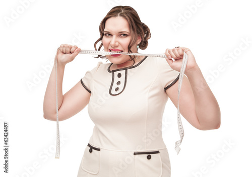 Photo: Beautiful plus size woman gnawing centimeter Beautiful plus size woman gnawing centimeter