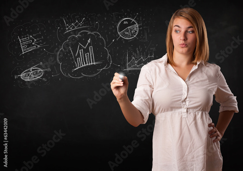 Photo: Young lady sketching financial chart icons and symbols Young lady sketching financial chart icons and symbols