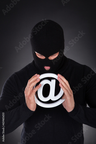 Photo: Hacker with an internet domain symbol Hacker with an internet domain symbol