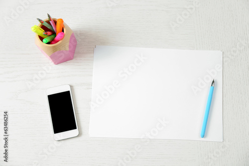 Photo: Blank paper and pen on wooden table Blank paper and pen on wooden table
