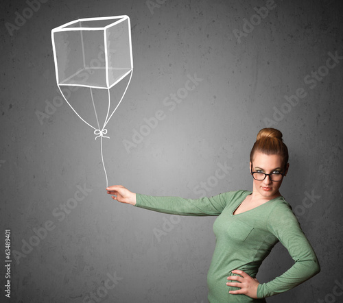 Photo: Woman holding a cube balloon Woman holding a cube balloon