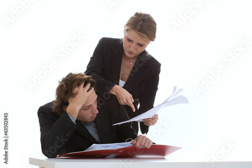 Photo: Overworked employee and exigent leader Overworked employee and exigent leader