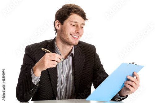 Photo: Young male employee during job Young male employee during job