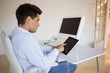Businessman working on his tablet at his desk Businessman working on his tablet at his desk