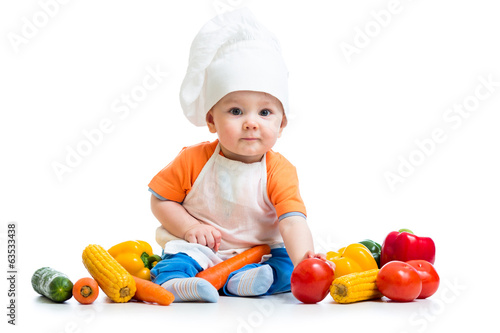 Photo: baby chef with healthy food vegetables baby chef with healthy food vegetables