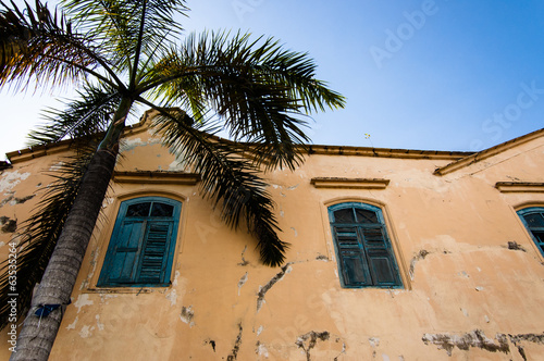 Photo: Old crumbling building with palm tree Old crumbling building with palm tree
