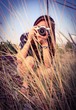 Pretty photographer is shooting the grassland Pretty photographer is shooting the grassland