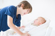 Happy laughing boy talking to his newborn baby brother Happy laughing boy talking to his newborn baby brother