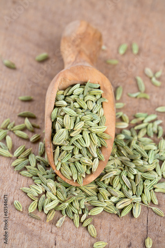 Photo: fennel seed in a wooden scoop on table fennel seed in a wooden scoop on table