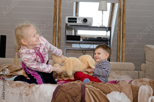 Photo: Cute brother and sister having a tug of war Cute brother and sister having a tug of war