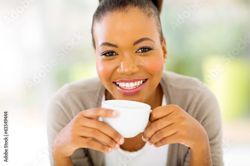 Photo: african woman drinking coffee in the morning african woman drinking coffee in the morning