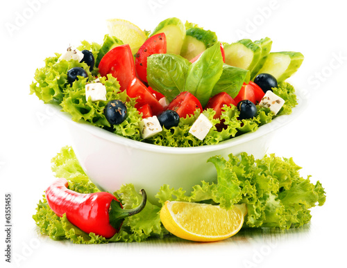 Photo: Vegetable salad bowl isolated on white Vegetable salad bowl isolated on white