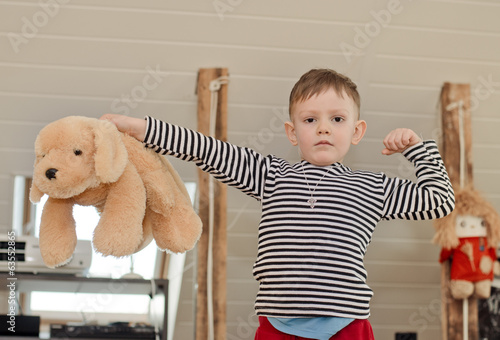 Photo: Little boy showing off his muscles Little boy showing off his muscles