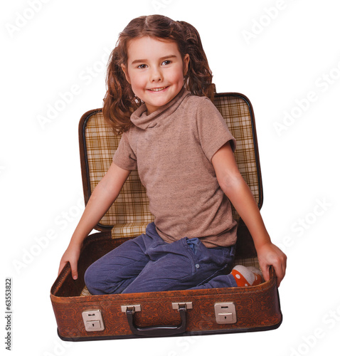 Photo: girl baby brunette sitting in a suitcase for travel isolated on girl baby brunette sitting in a suitcase for travel isolated on