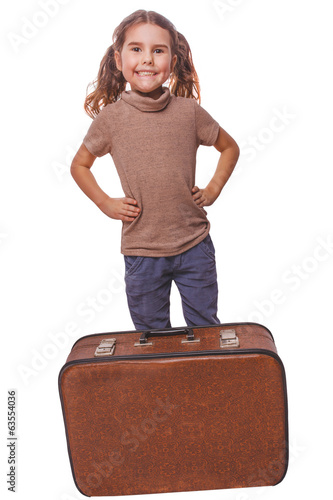 Photo: brunette girl smiling child standing next to suitcase for travel brunette girl smiling child standing next to suitcase for travel