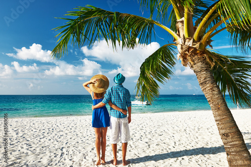 Photo: Couple in blue clothes on a beach at Maldives Couple in blue clothes on a beach at Maldives
