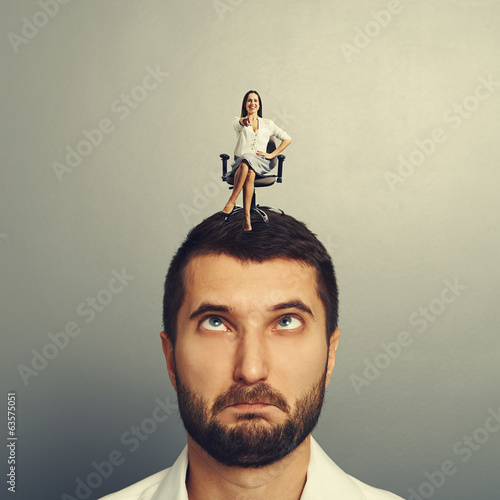 Photo: stressed man with smiley woman stressed man with smiley woman