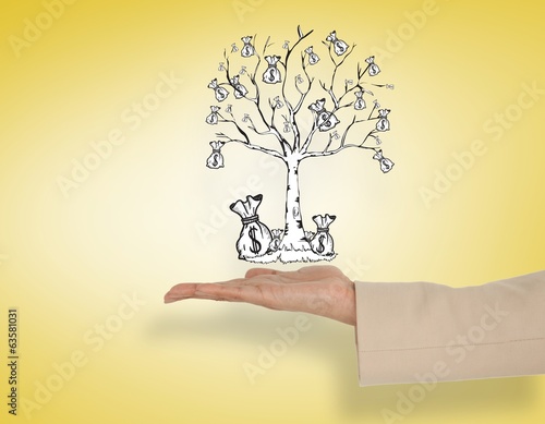 Photo: Composite image of female hand presenting money tree Composite image of female hand presenting money tree
