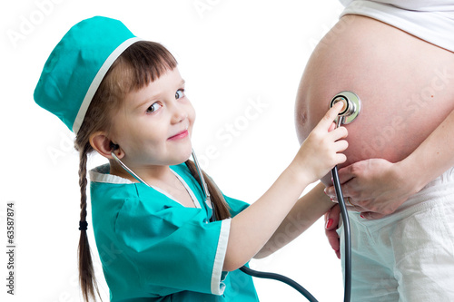 Photo: doctor kid girl listening to pregnant mother's belly doctor kid girl listening to pregnant mother's belly