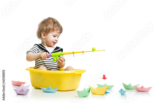 Photo: Kid boy plays fishing Kid boy plays fishing