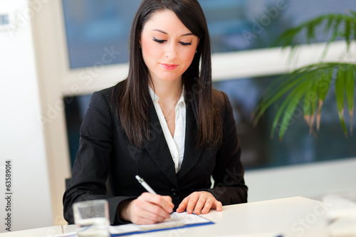 Photo: Smiling businesswoman in the office Smiling businesswoman in the office