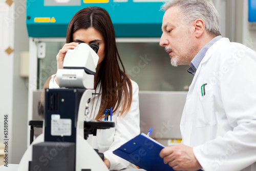 Photo: Couple of scientist researching in a laboratory Couple of scientist researching in a laboratory