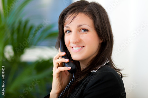 Photo: Smiling businesswoman at the phone Smiling businesswoman at the phone