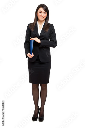 Photo: Businesswoman full length holding documents Businesswoman full length holding documents