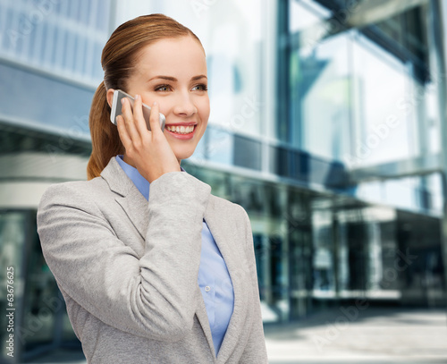 Photo: young smiling businesswoman with smartphone young smiling businesswoman with smartphone