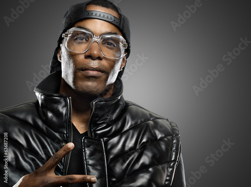 Photo: funky african american man with glasses on studio background. funky african american man with glasses on studio background.