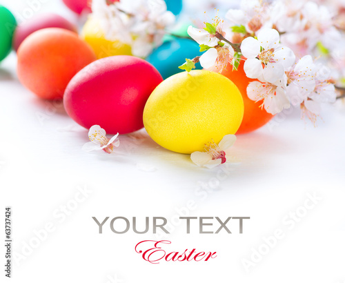 Photo: Easter. Colorful easter eggs with spring blossom flowers Easter. Colorful easter eggs with spring blossom flowers