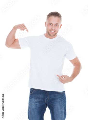Photo: Man pointing at his blank white t-shirt Man pointing at his blank white t-shirt