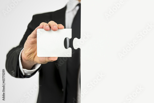 Photo: Businessman with a piece of the puzzle Businessman with a piece of the puzzle
